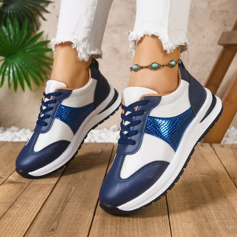 Blue and white lace-up sneakers with textured blue accents and white soles.