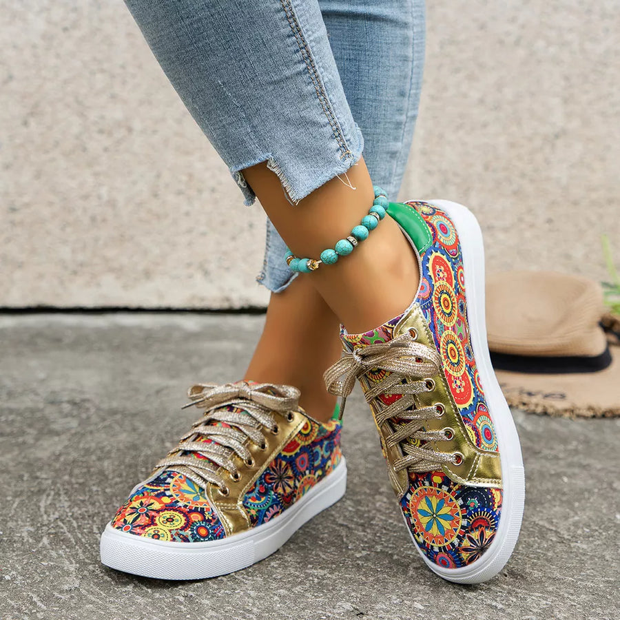 Mandala print round toe sneakers with gold laces and white soles.