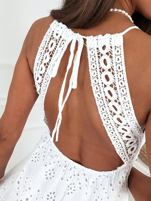 White eyelet lace mini dress with open back and tie detail.