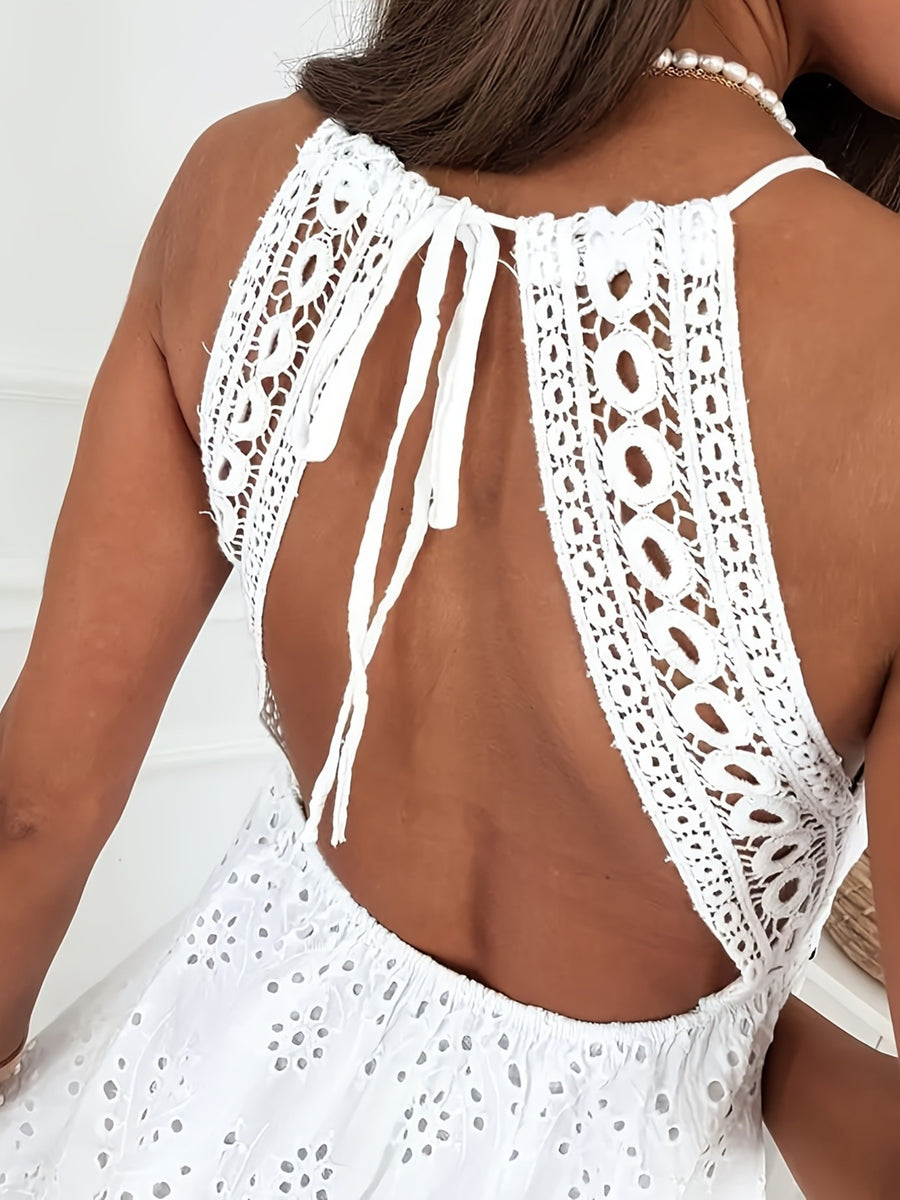 White eyelet lace mini dress with open back and tie detail.