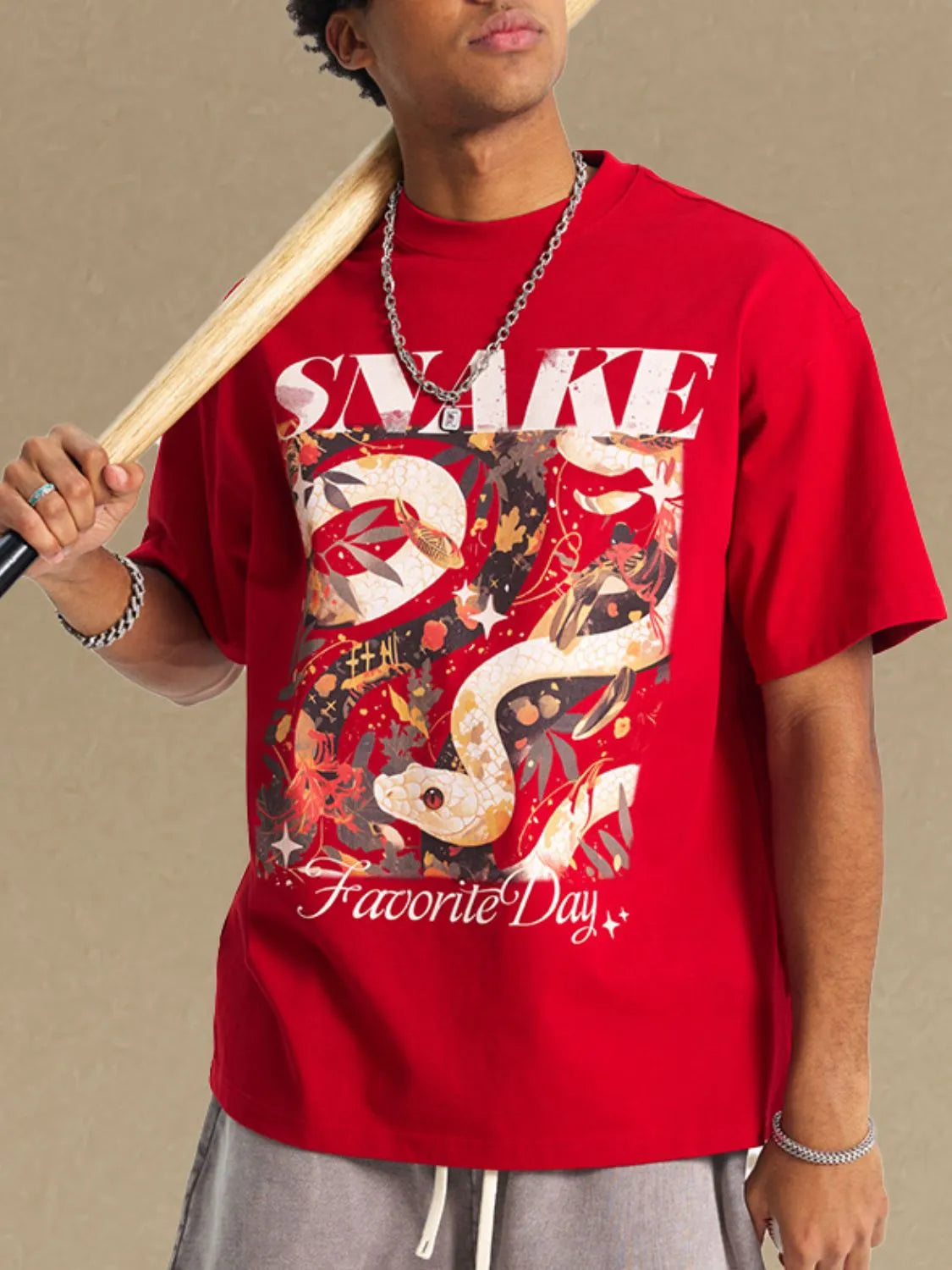 Red oversized graphic tee with a snake and floral design, crew neck, short sleeves.