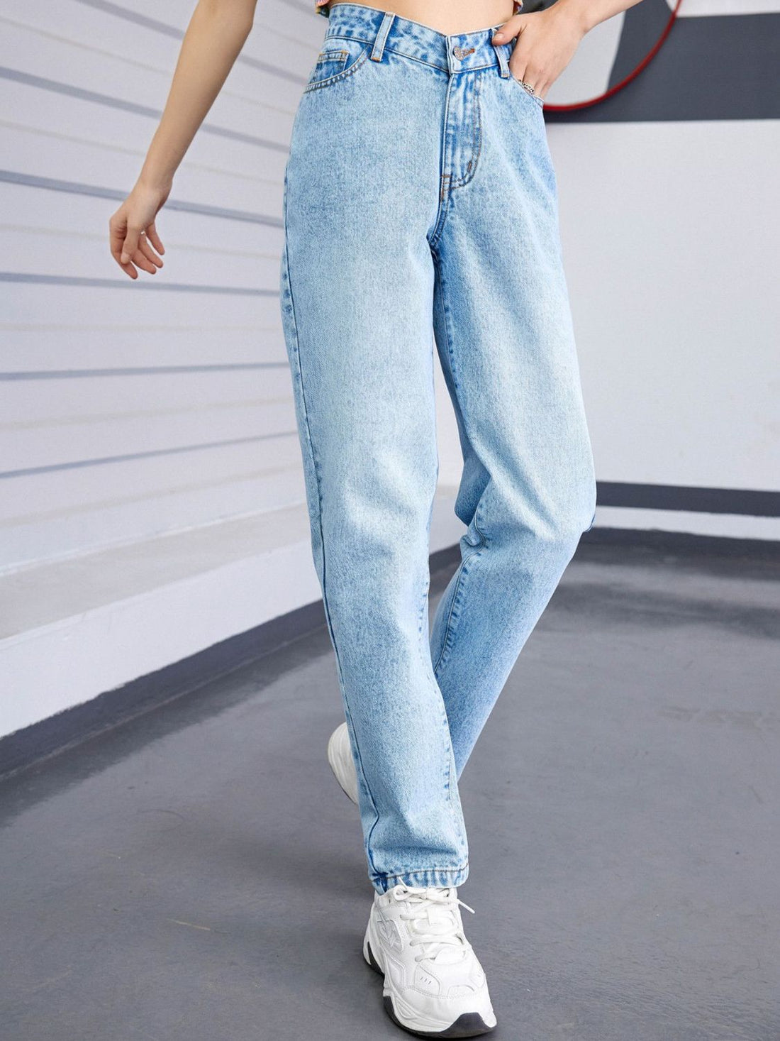 Light wash denim jeans with a V-waistline and relaxed fit.
