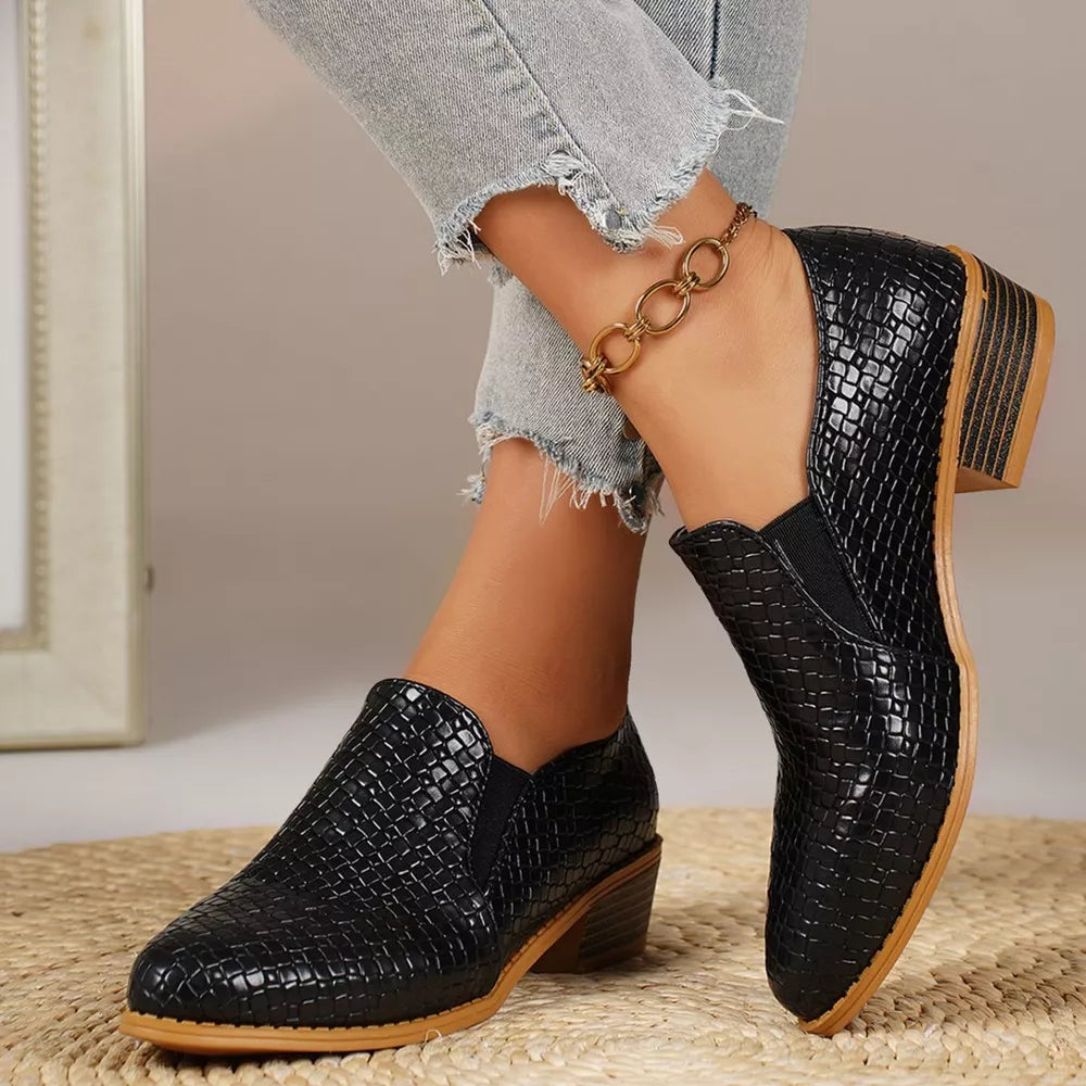 Black woven texture pointed loafers with block heels and elastic side panels.