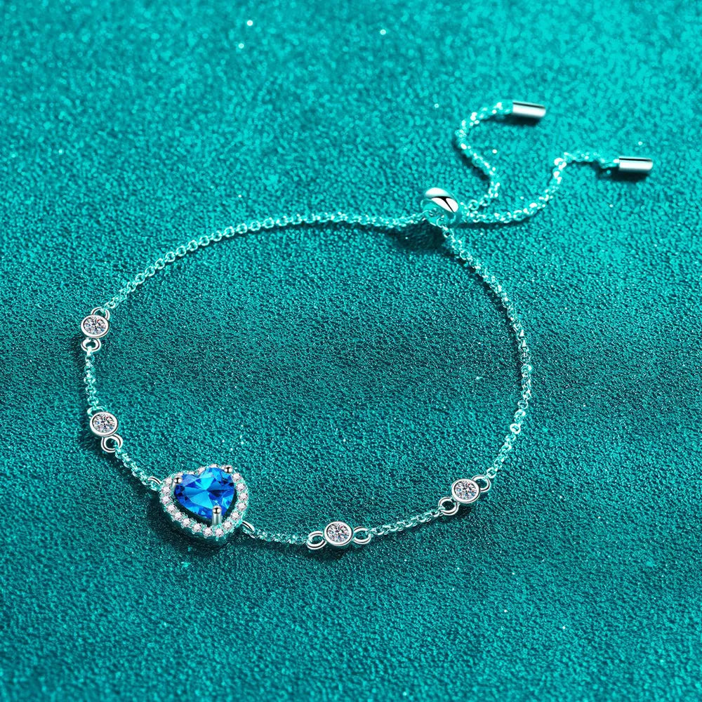 Blue heart halo moissanite adjustable bracelet with clear accent stones.