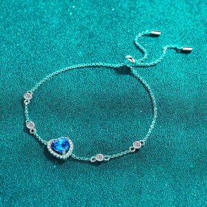 Blue heart halo moissanite adjustable bracelet with clear accent stones.