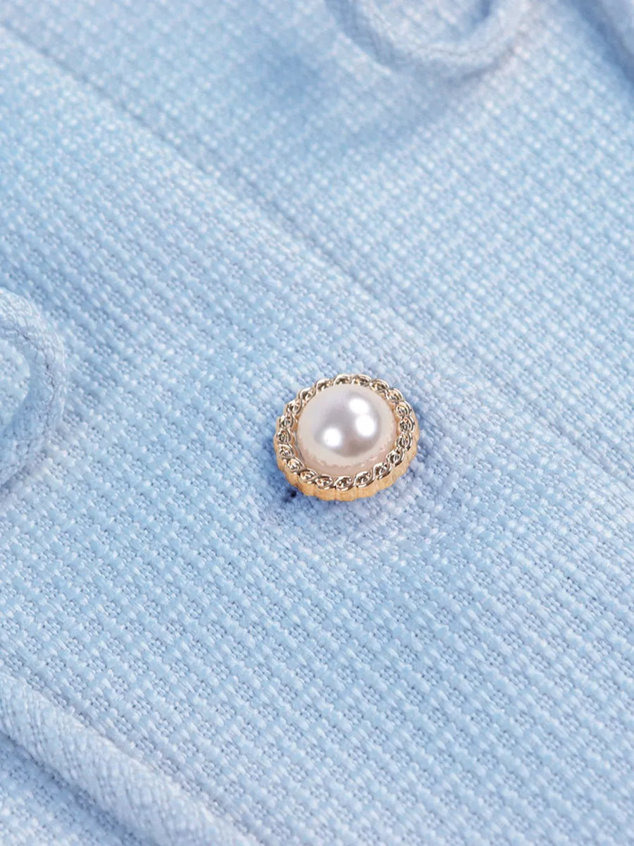 Light blue textured knit cardigan with pearl and gold button detail.
