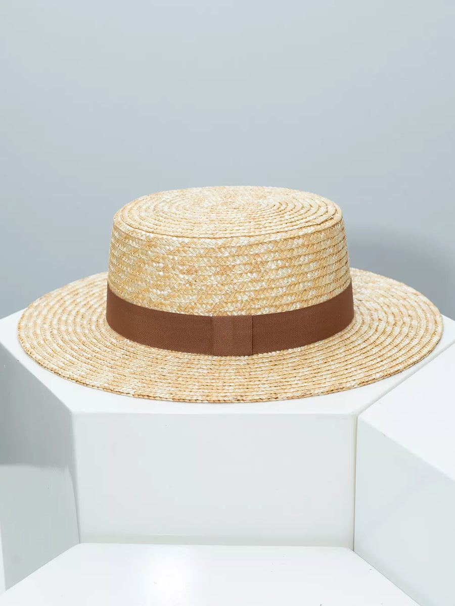Women's straw boater hat with brown ribbon band