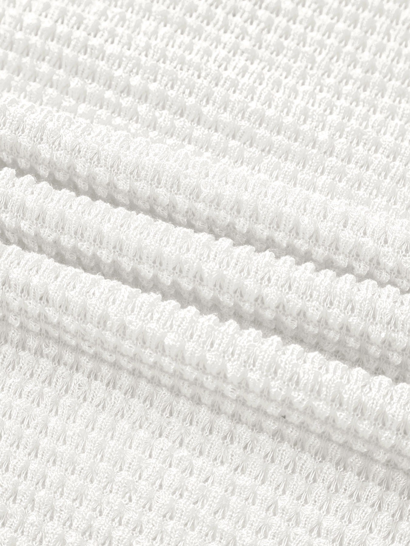 White waffle knit button-up shirt with elastane, showing fabric texture.