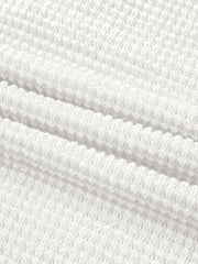 White waffle knit button-up shirt with elastane, showing fabric texture.