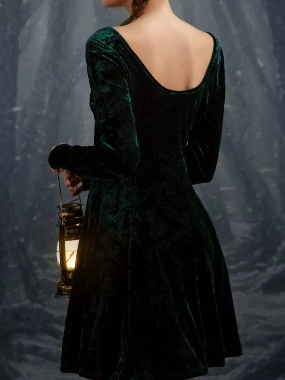 Green velvet gown with long sleeves and a scoop neck, shown from the back.