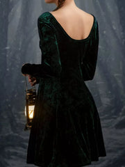 Green velvet gown with long sleeves and a scoop neck, shown from the back.