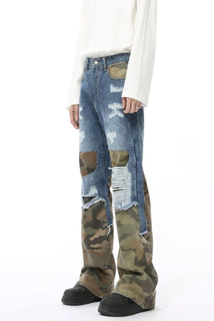 Camouflage panel distressed wide-leg jeans in blue denim with ripped details.