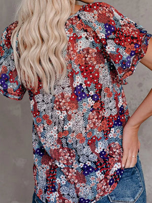 Floral print v-neck blouse with tie detail and flutter sleeves, red and blue.