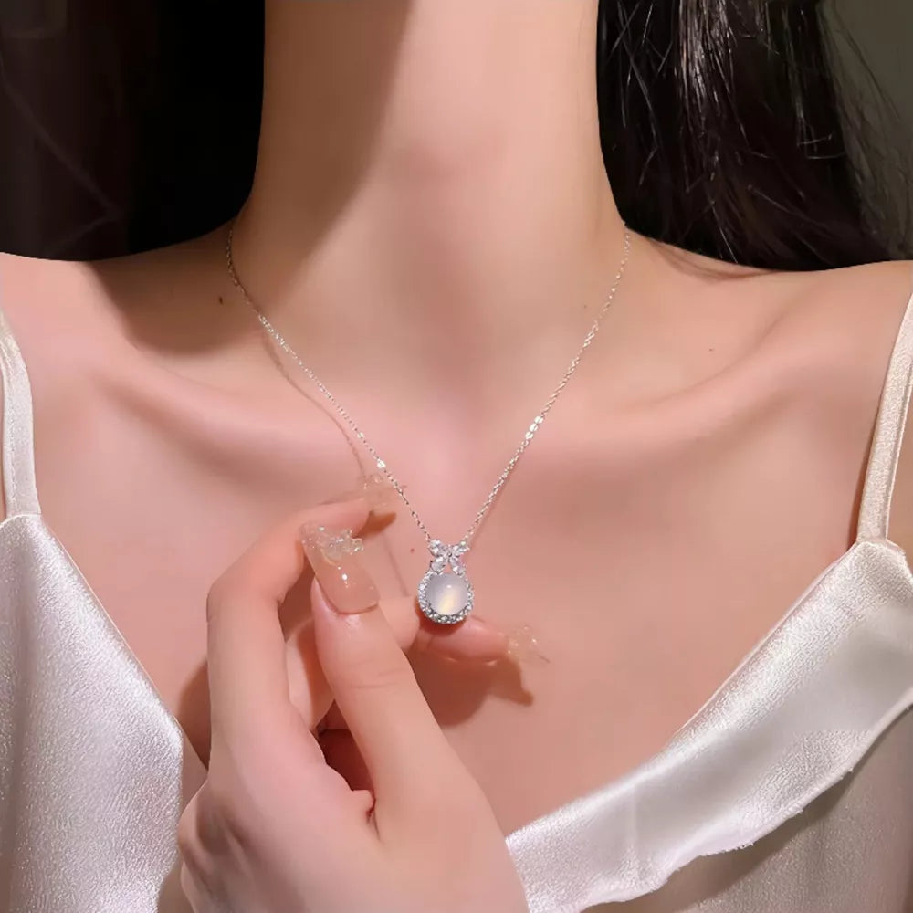 Sterling silver necklace with oval chalcedony pendant and crystal accents.