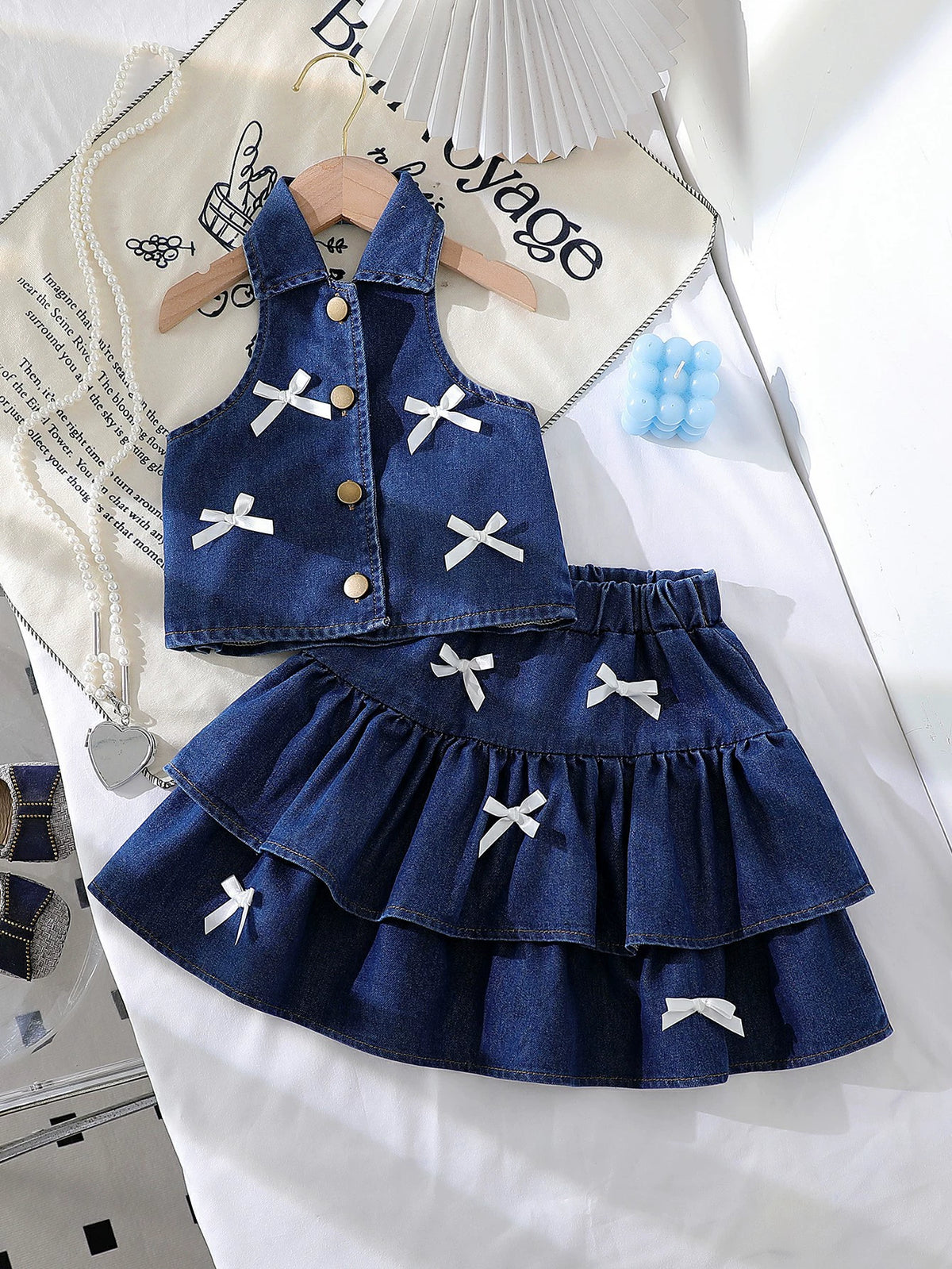 Denim halter vest and tiered skirt set with white bow accents