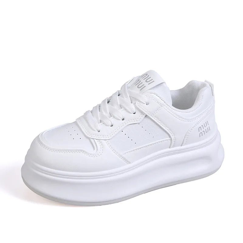 White platform court sneakers with contrast detail and embossed logo.