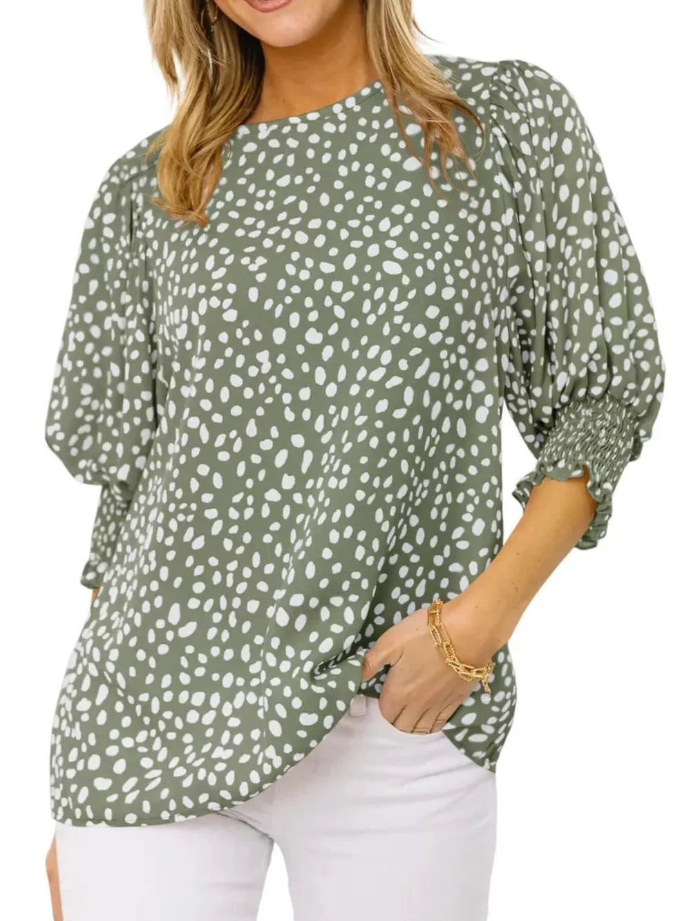 Green animal print blouse with half sleeves and smocked cuffs.
