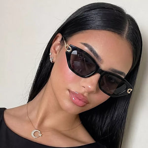 sunglasses in black featuring UV400 protection and cat-eye fit