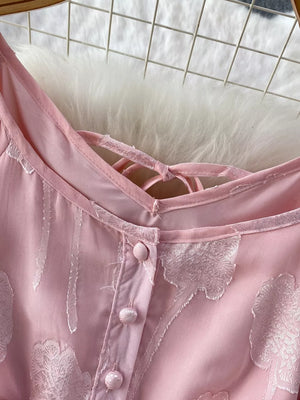 Pink chiffon maxi dress with floral embroidery and button-down front.