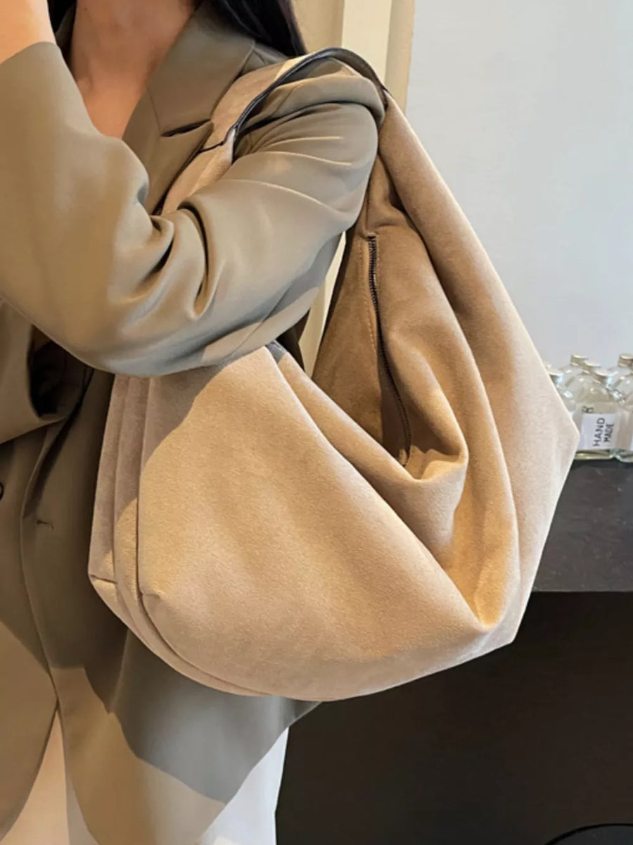 Spacious off-white suede shoulder bag with zipper pocket detail