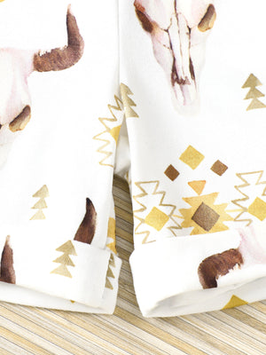 White cotton blend baby outfit with bull skull and geometric print.