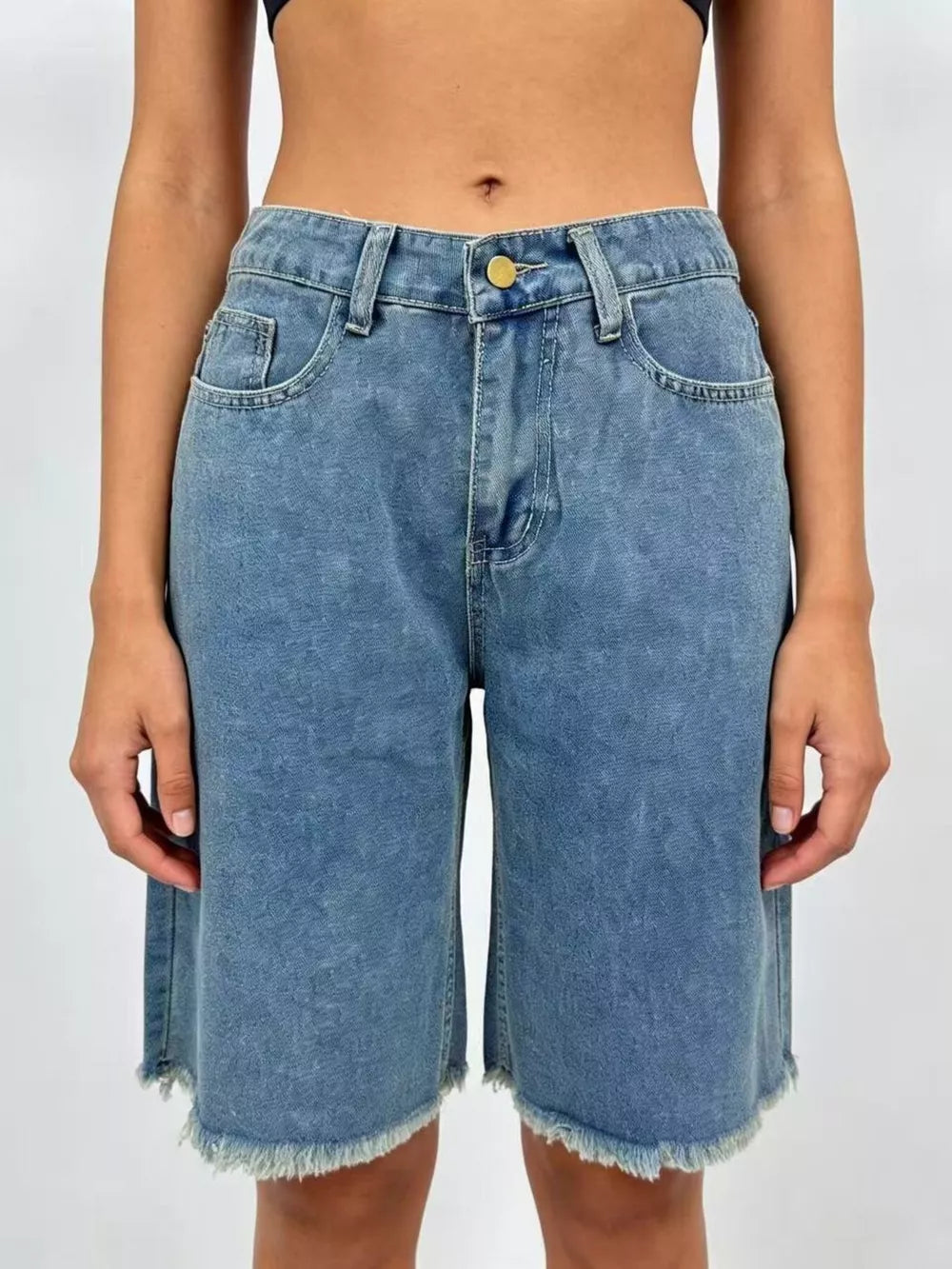 Blue denim bermuda shorts with frayed hem and relaxed fit.