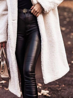 Creamy-white teddy bear longline coat with button closure, styled with black leather pants.