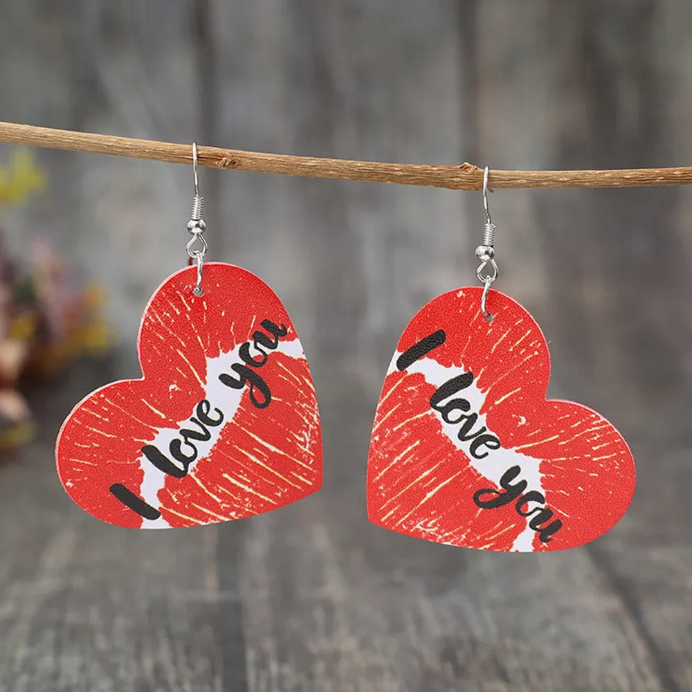 Red heart drop earrings with kiss print and "I love you" text.