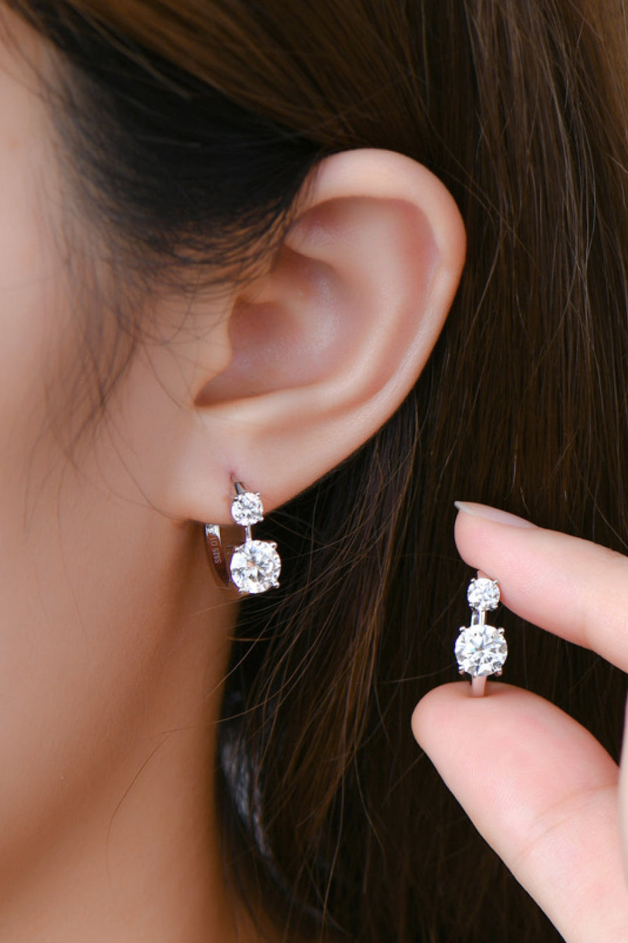 Silver double stone huggie hoop earrings with two sparkling cubic zirconia stones.