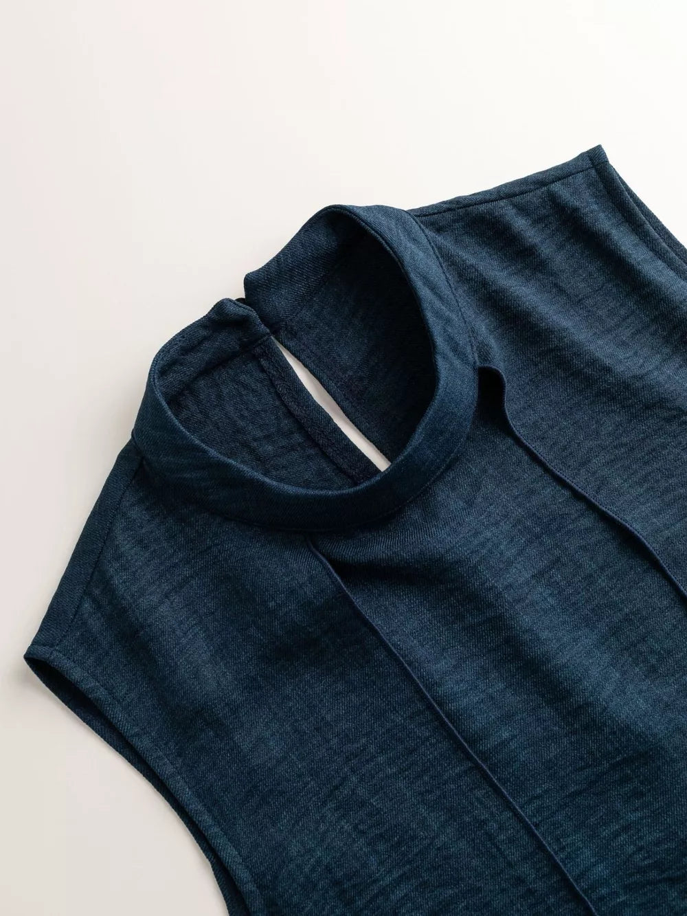 Chic mock neck sleeveless tank top in dark navy with a keyhole back detail.