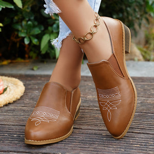 brown loafers featuring point toe and embroidered