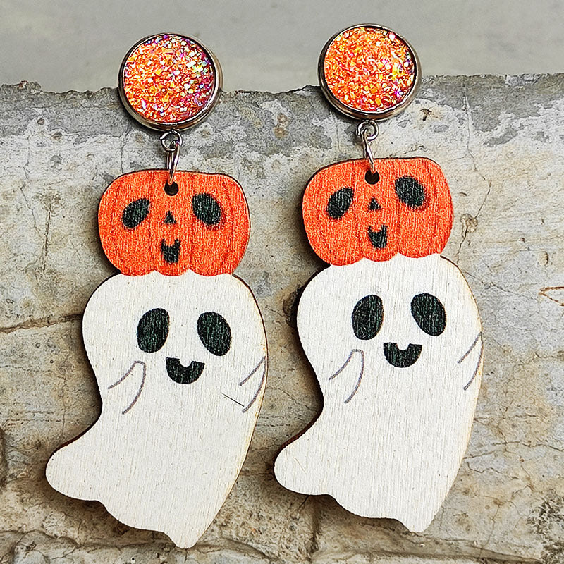 Spooky ghost and pumpkin dangle earrings with orange glitter studs.
