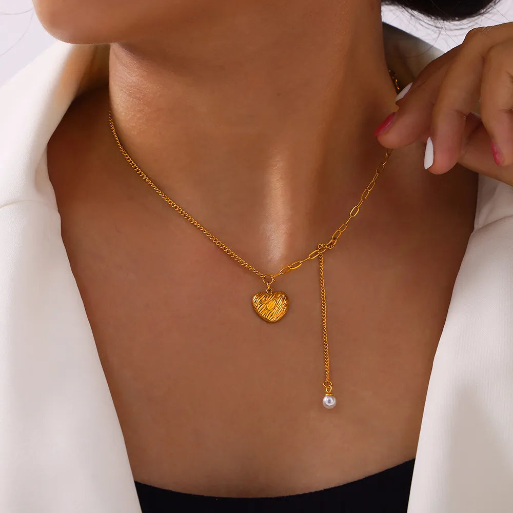Gold textured heart and pearl drop necklace with adjustable chain