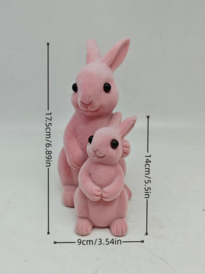 Charming pink flocked bunny decorative ornaments, one large and one small, with black eyes.