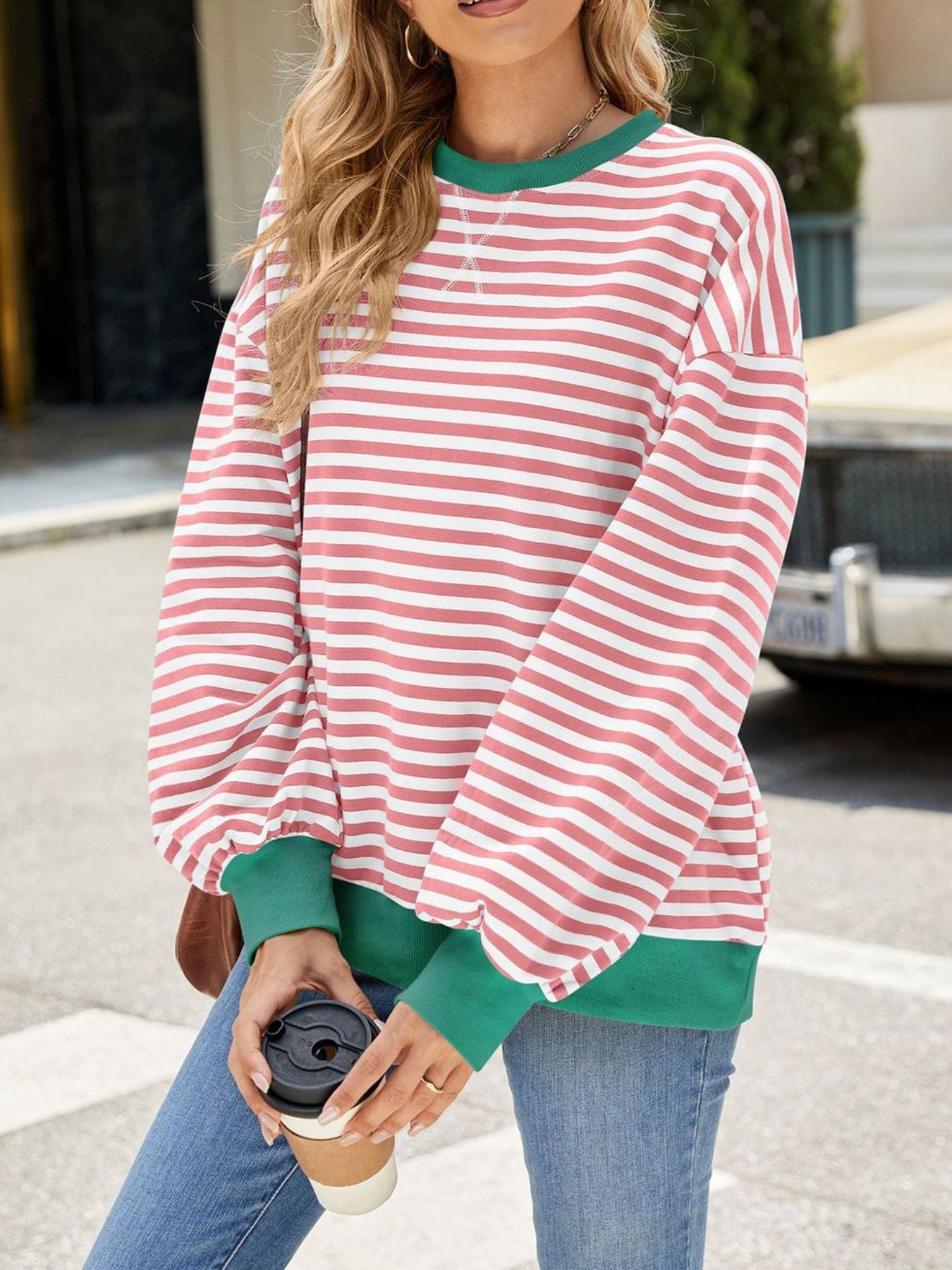 Striped crew neck sweatshirt with green trim and balloon sleeves.