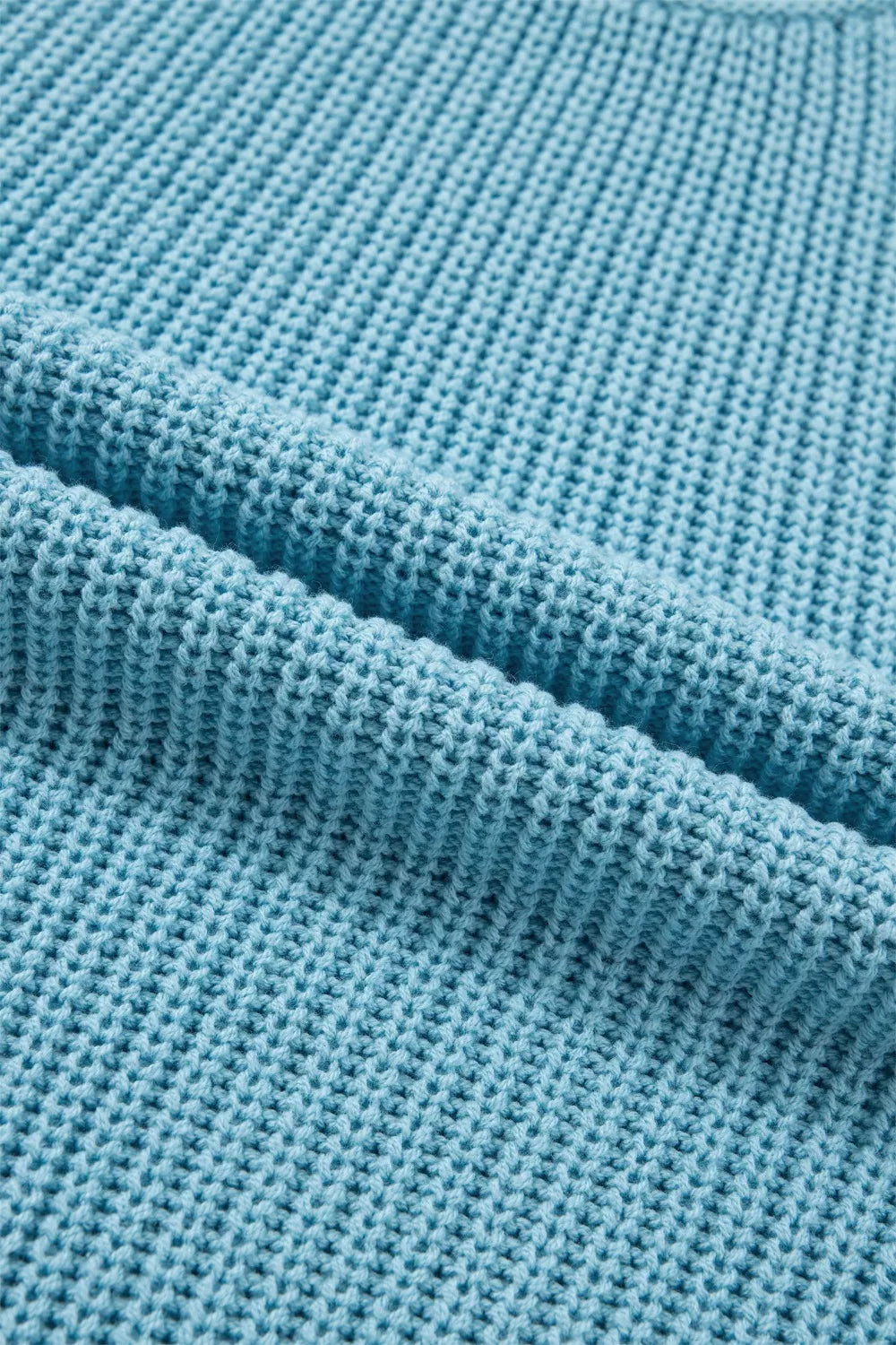 Relaxed ribbed knit sweater top in blue cotton with a textured stitch detail.