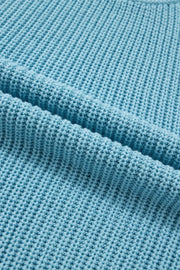 Relaxed ribbed knit sweater top in blue cotton with a textured stitch detail.