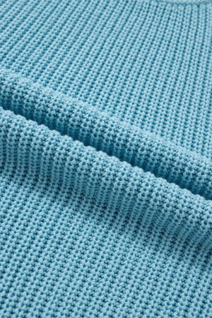 Relaxed ribbed knit sweater top in blue cotton with a textured stitch detail.