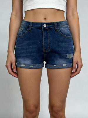 Dark blue distressed denim roll-up shorts with button fly and cuffed hems.