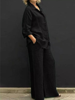 Black relaxed two-piece set with buttoned collared top and wide-leg pants.