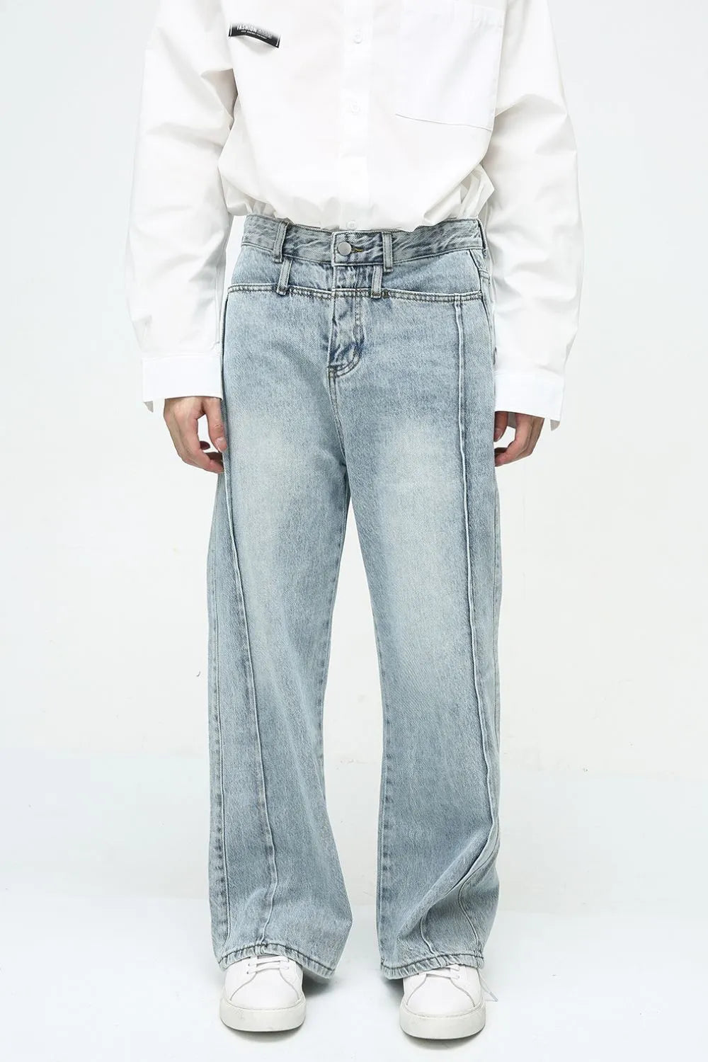 Medium wash wide-leg denim jeans with vertical seam detail