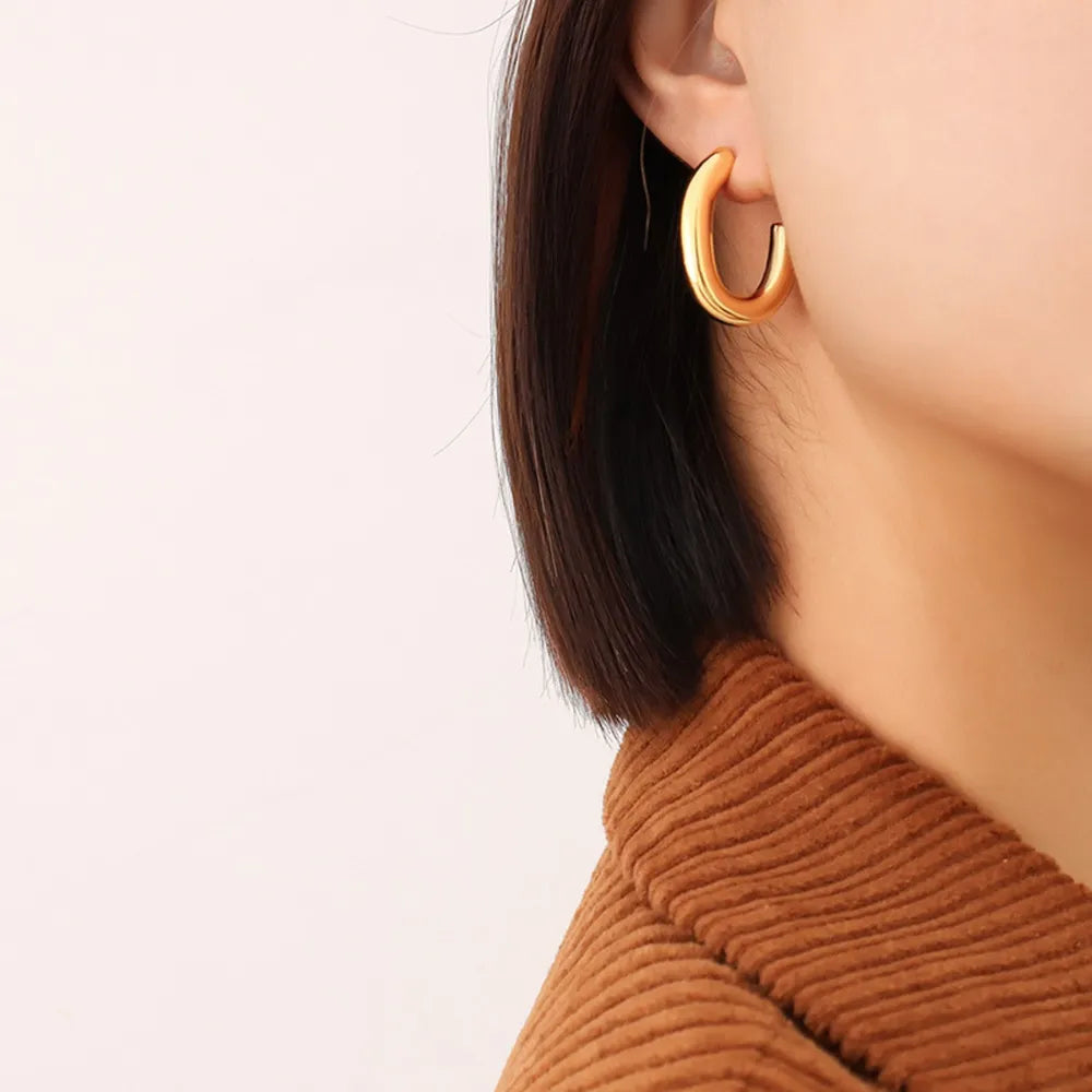 Gold vermeil sculpted hoop earrings with a smooth, polished finish.