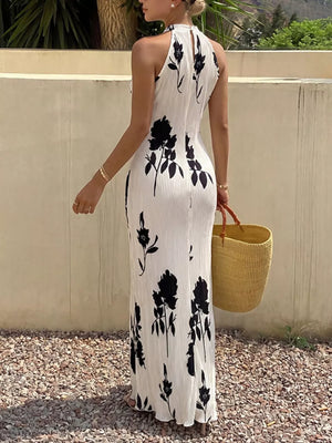 White floral print halter maxi dress with pleated fabric and a-line cut.