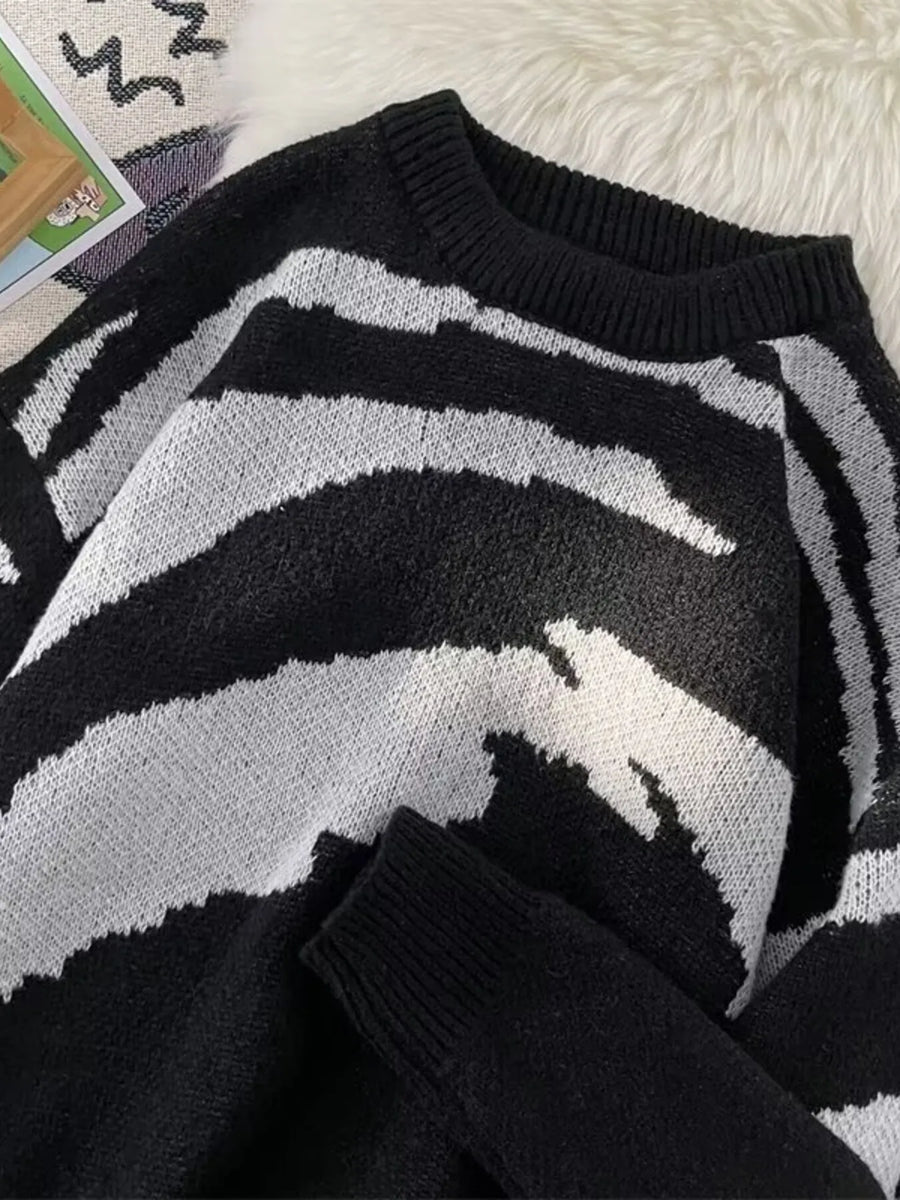 Men's black and white abstract print round-neck sweater with ribbed cuffs.
