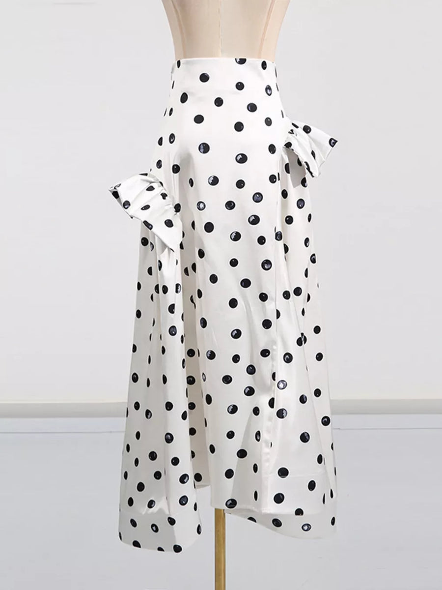 White polka dot midi dress with ruffled sleeves and a high waist.
