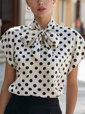 White polka dot shirt with bow tie neck and cap sleeves