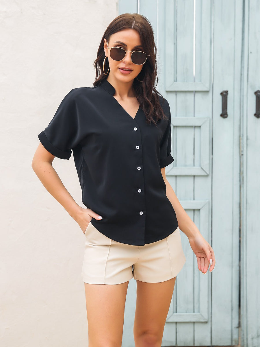 Black short sleeve buttoned blouse with a notch neckline.