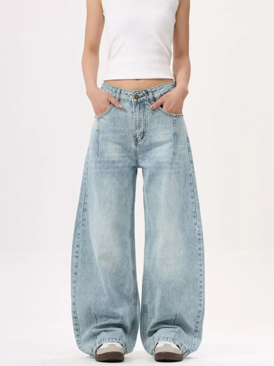Men's light blue wide-leg stretch jeans with a relaxed fit.
