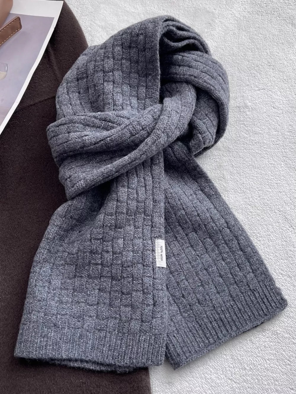 Luxurious dual knit wool scarf in dark gray with basketweave texture.