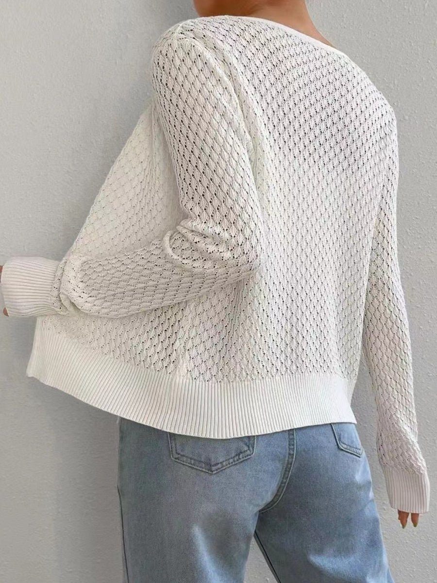 White openwork knit cardigan with a diamond pattern and ribbed cuffs and hem.